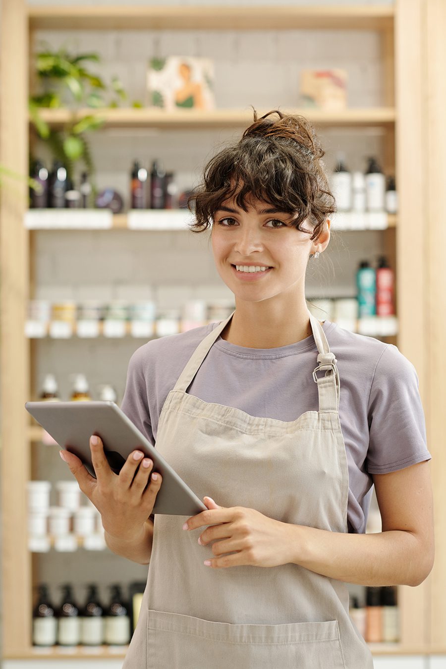 Young business woman standing in front of shelves